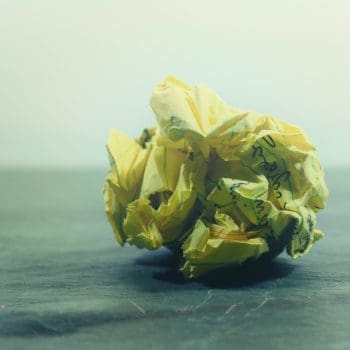 A crumpled up piece of yellow paper